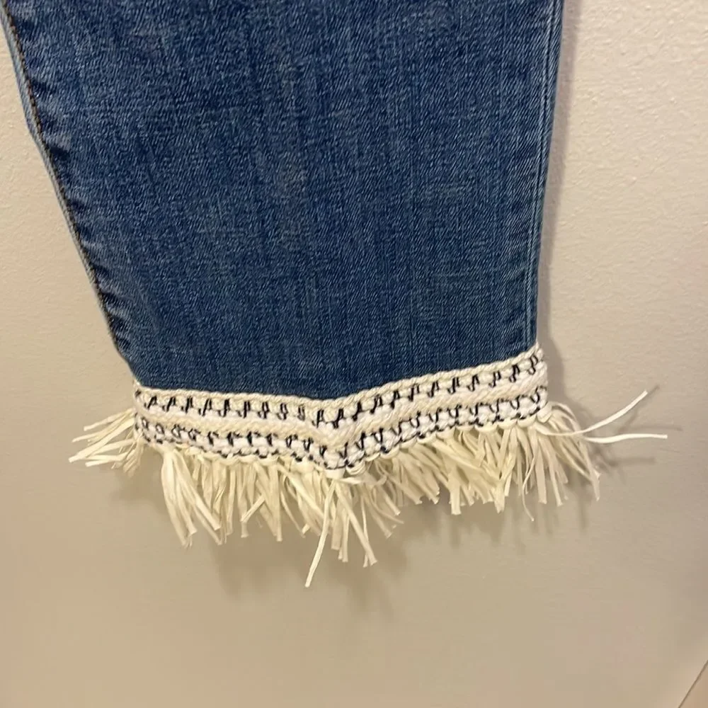 Tory Burch Connor jeans in medium allover stone wash. Cropped. Raffia fringed